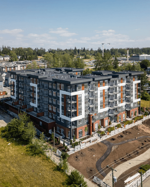 Exterior view of the finished Eastin modern residential building in Langley, showcasing the building facade and windows.