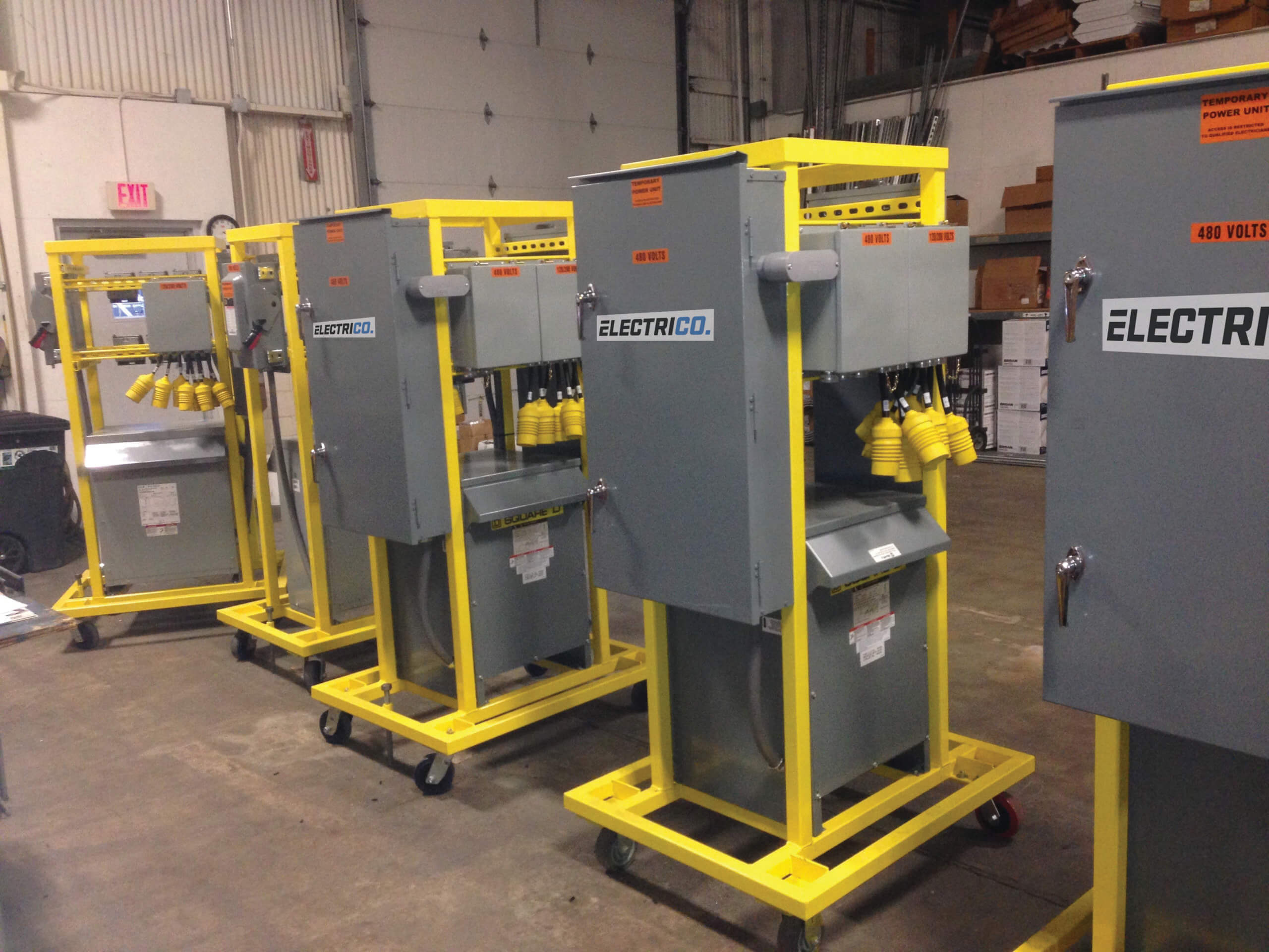Row of temporary power distribution units for rental.