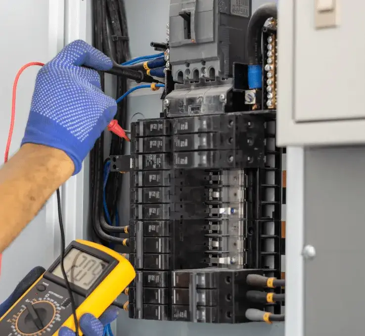 Hand plugging an electrical cord into a wall outlet, representing responsive service and small electrical jobs.